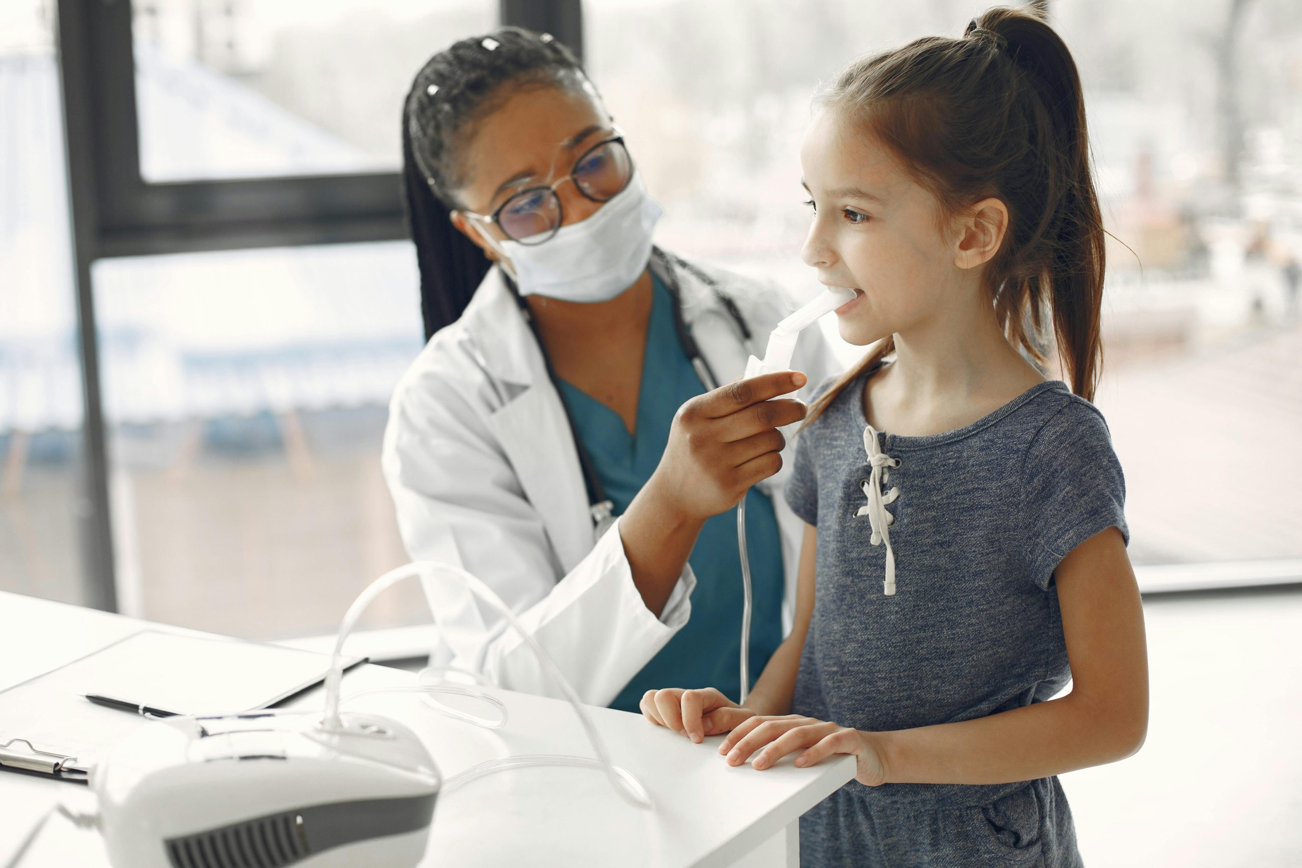 Doctor performing breathing test on young girl