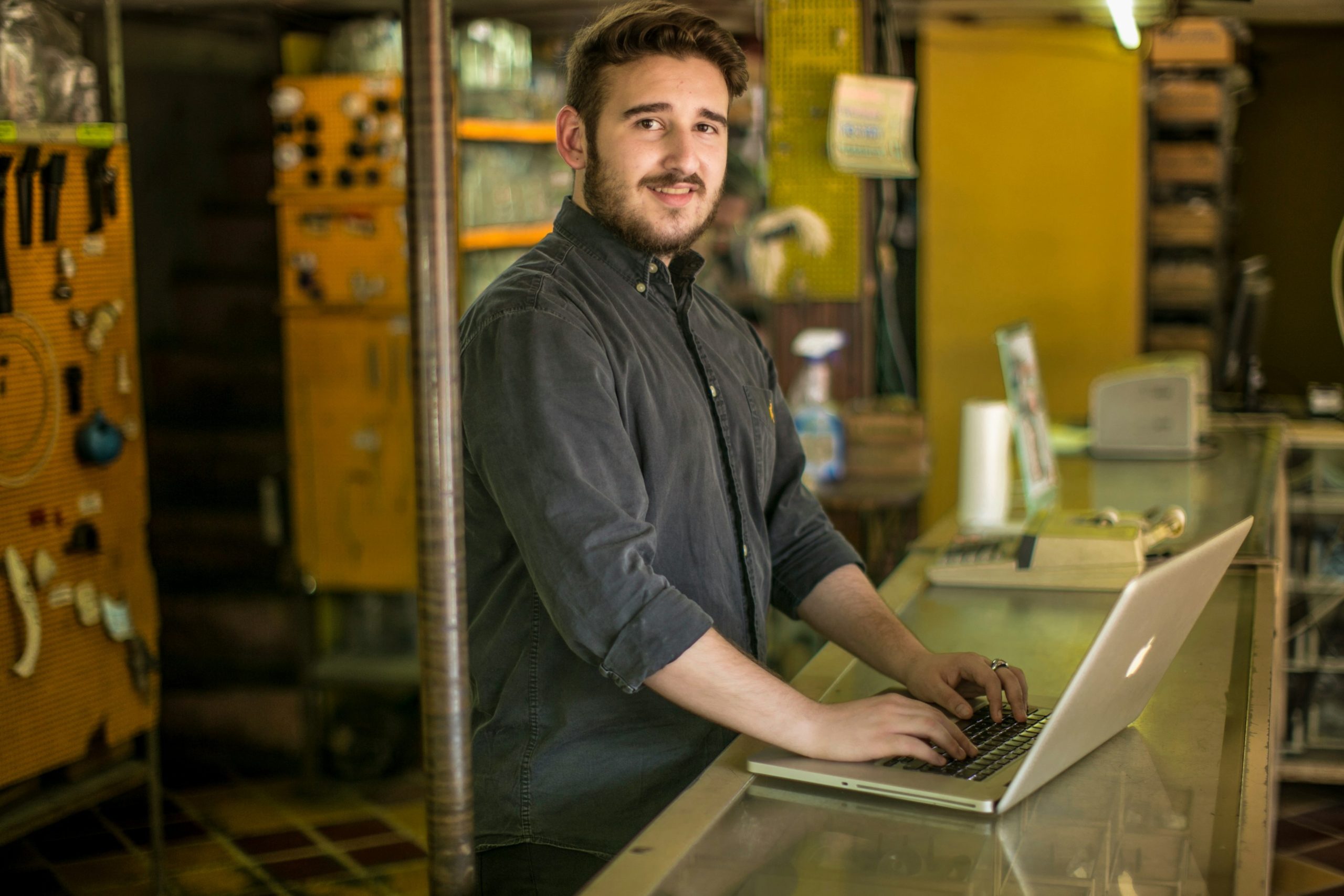 Man using laptop in plumbing services front desk